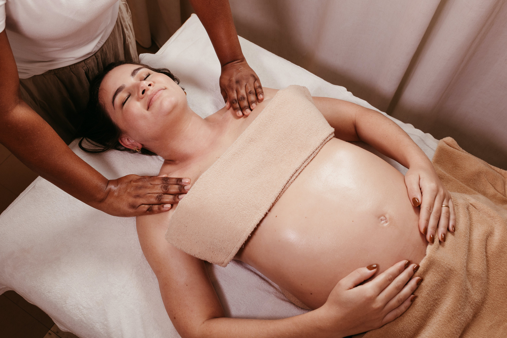 A pregnant woman getting a massage in a spa